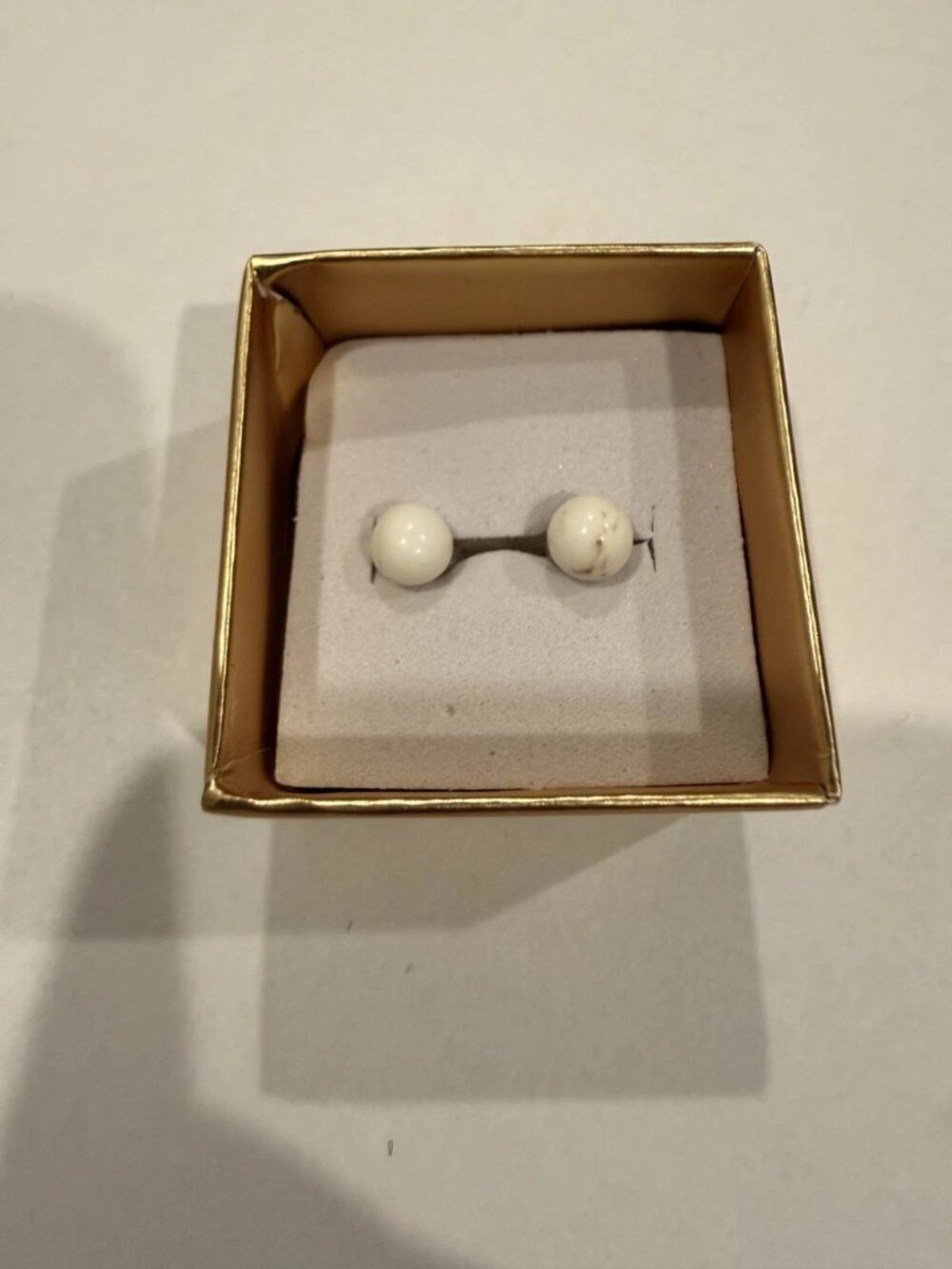 Beautiful 10K gold earrings with smaller round white stone.